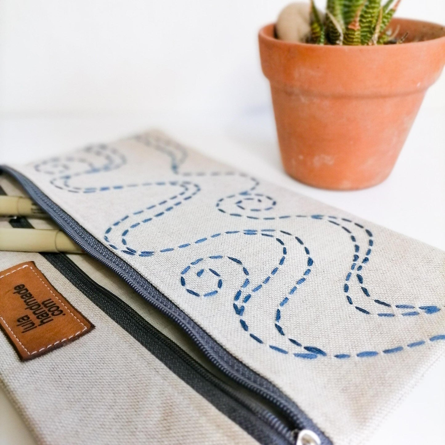 blue waves depicting ocean on linen zipper pouch