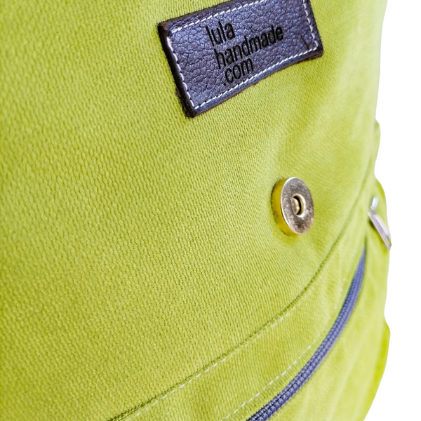 Lined Back Pack with inner and outer pockets, made with apple green velour fabric. Cotton webbing handles and adjustable sling. Close up view of fabric