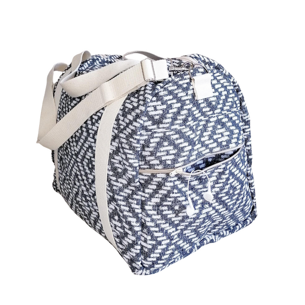 Large Duffel Bag with multiple inner and outer pockets, made with fabric with black & white dimaond motive. Cotton webbing handles and adjustable sling. Side View