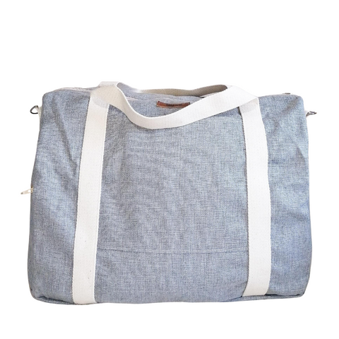 Large Duffel Bag with multiple inner and outer pockets, made with light grey fabric. Cotton webbing handles and adjustable sling. Front view