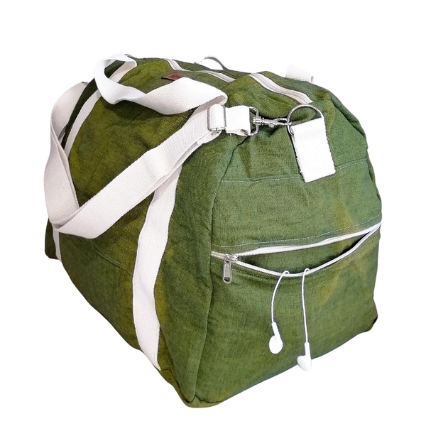 Large Duffel Bag with multiple inner and outer pockets, made with green lightweight denim fabric. Cotton webbing handles and adjustable sling. Side view