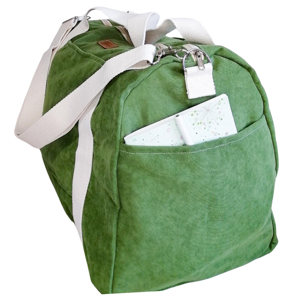 Large Duffel Bag with multiple inner and outer pockets, made with grass green velour fabric. Cotton webbing handles and adjustable sling. Side view
