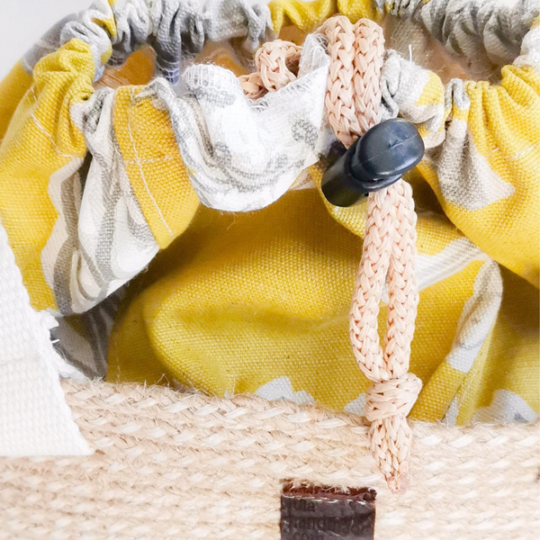 Drawstring Rope Hand Bag with Jute Rope and Yellow flower. Close up..