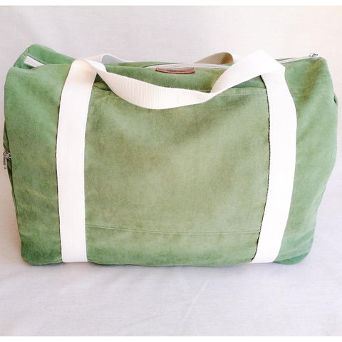Large Duffel Bag with multiple inner and outer pockets, made with grass green velour fabric. Cotton webbing handles and adjustable sling. Front view