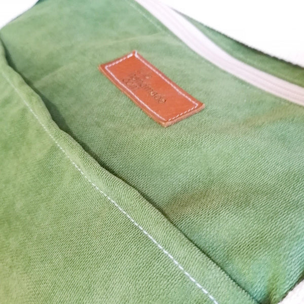 Large Duffel Bag with multiple inner and outer pockets, made with grass green velour fabric. Cotton webbing handles and adjustable sling. Close up view of fabric