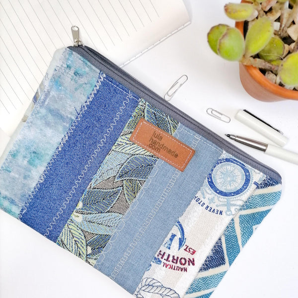 Lined zipper pouch made using strips of fabric in shades of blue